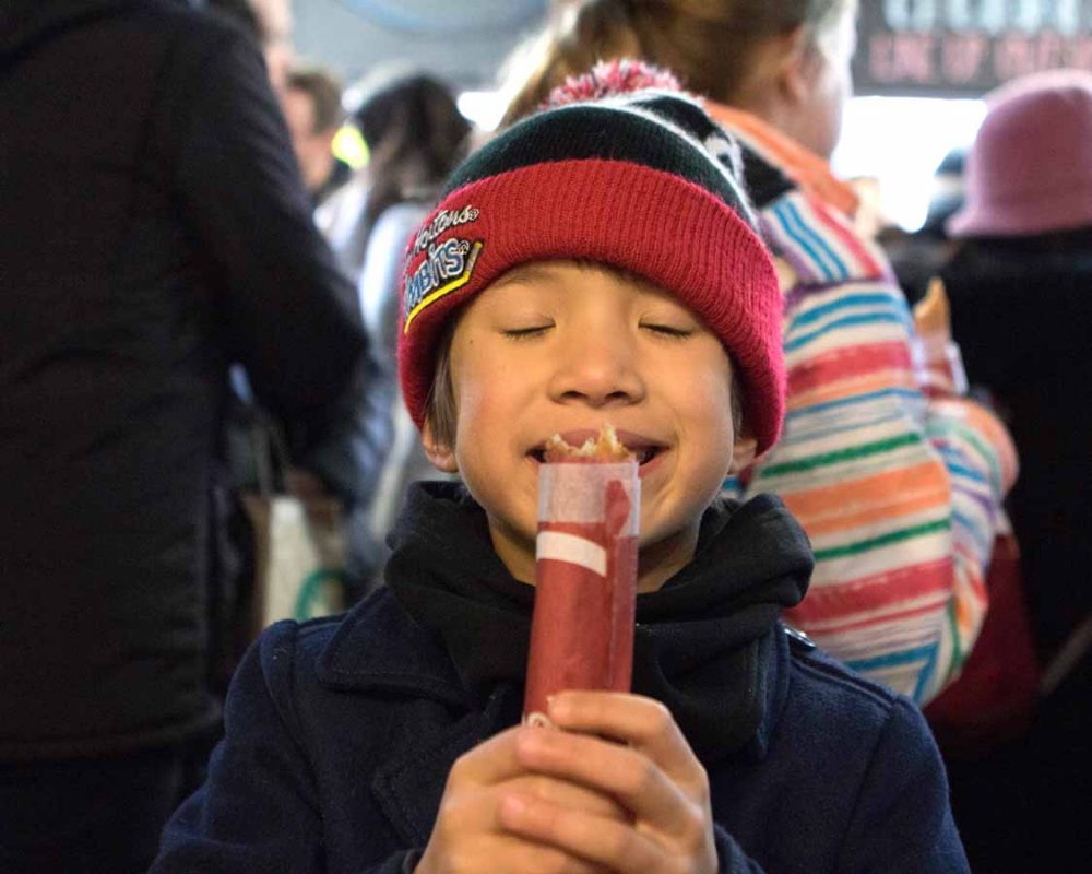 Young boy enjoying an Ontario food tou in Toronto