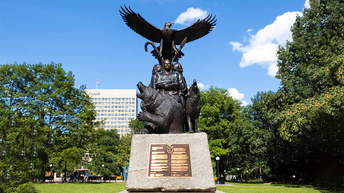 Monument feature Indigenous soldiers surrounded by a wolf and bear and topped by a Golden Eagle