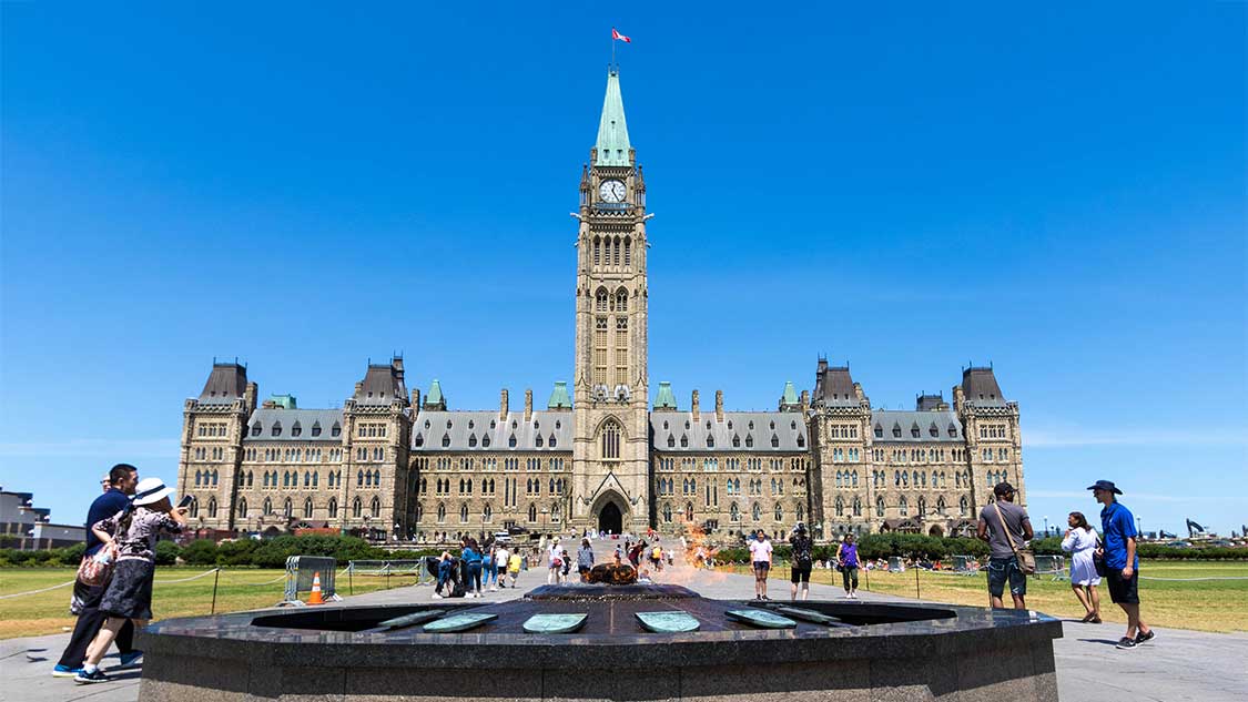 The Canadian Parliament Buildings centred in front of the eternal flame