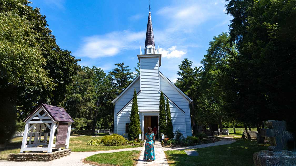 A woman standing outside of the Mohawk Chapel in Brantford, Ontario