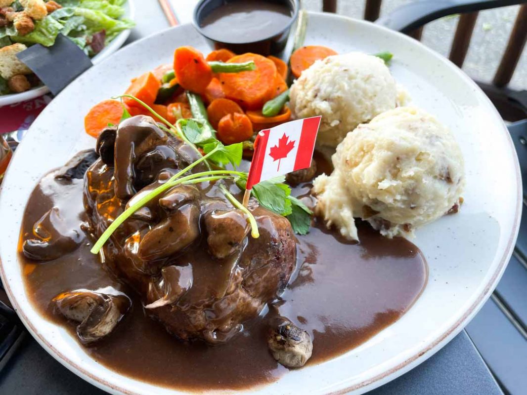 Gravy covered steak with a Canadian flag