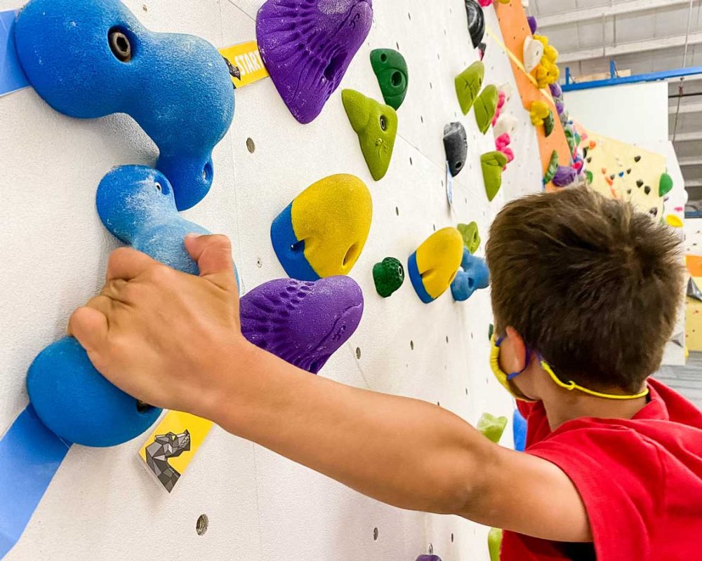 A boy bouldering in Mississauga