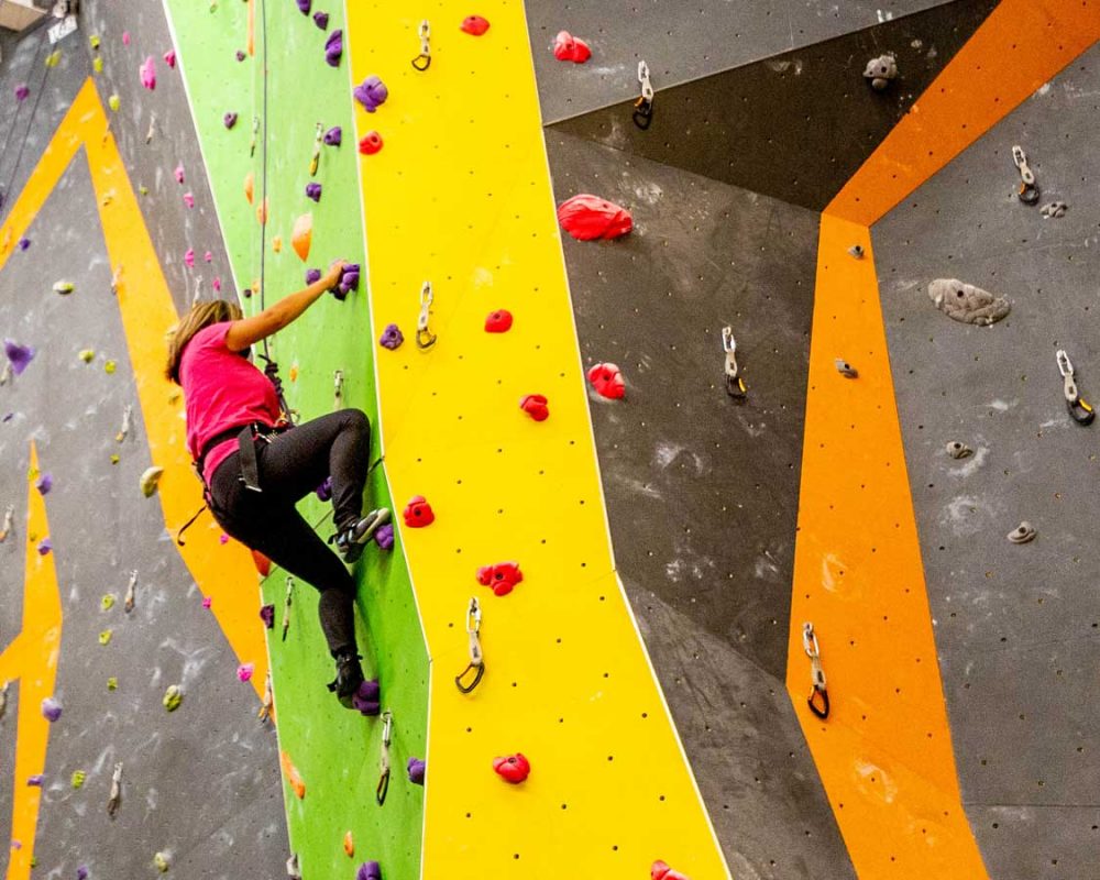 Woman indoor rock climbing in Mississauga