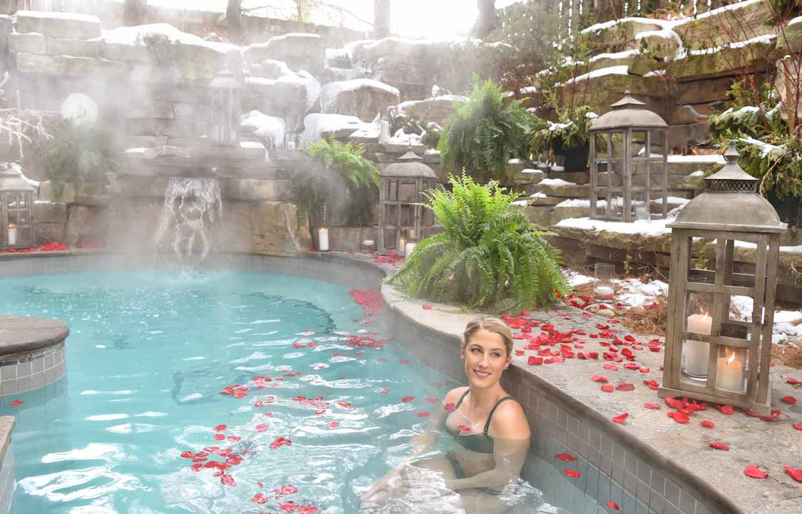 Woman relaxing in a pool at 100 Fountain Spa in Niagara-on-the-Lake, Ontario