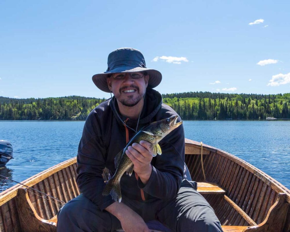 A man posing with a walleye while White River Ontario fishing