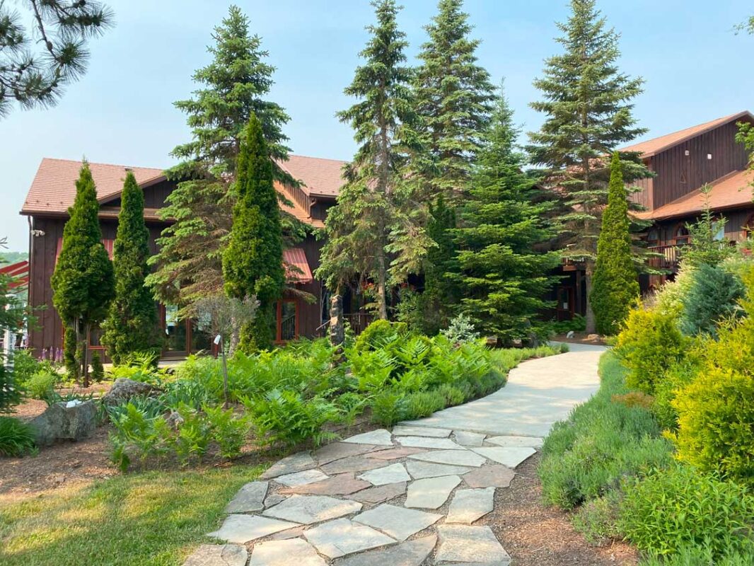 A large stone walkway leads up to a Bancroft wellness resort
