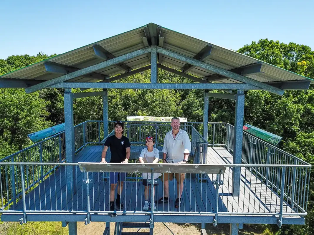 a father and his two sons look out from the top of an observation tower at Sager Conservation Area in Quinte West