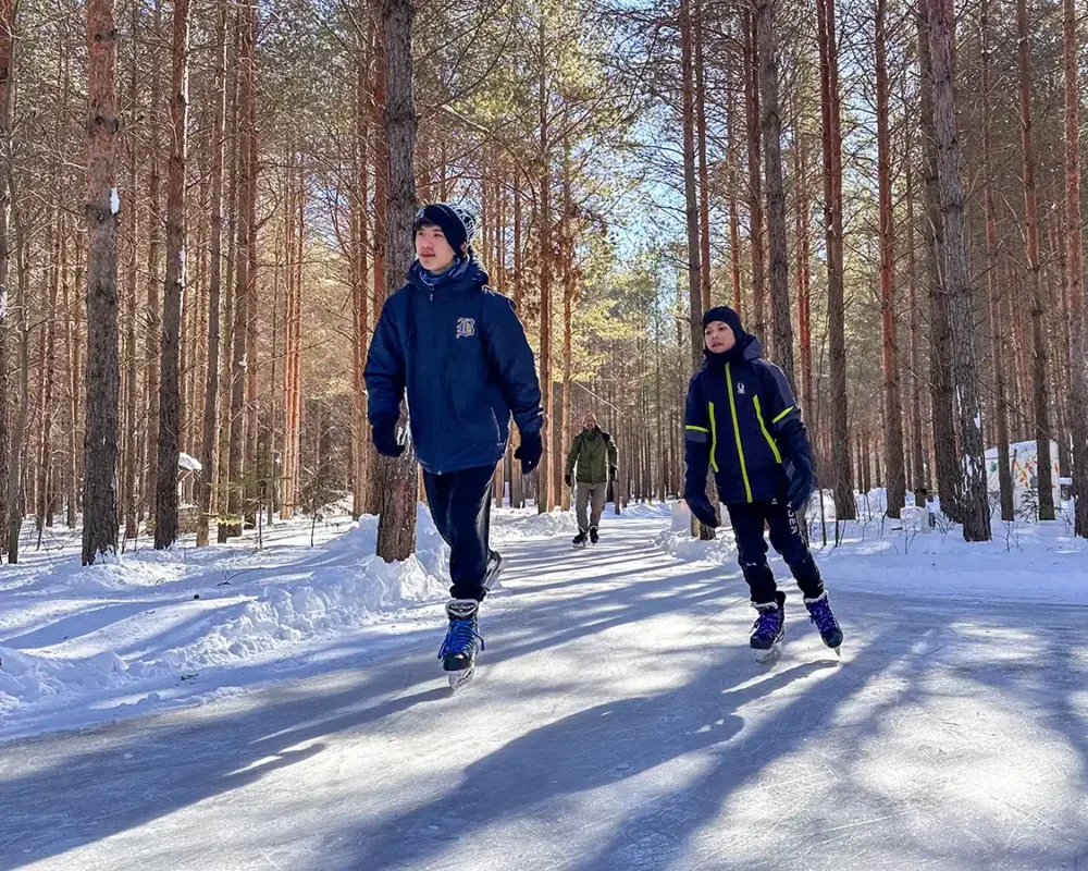 A family skating along icy trails on the Trans Canada Trails