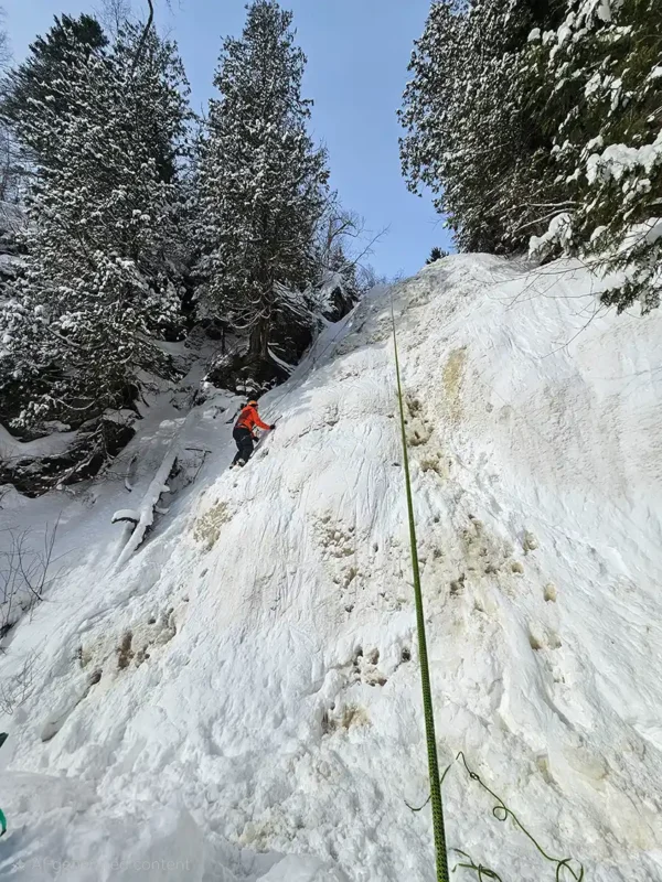 Kevin Wagar ice climbing up a waterfall in Thunder Bay