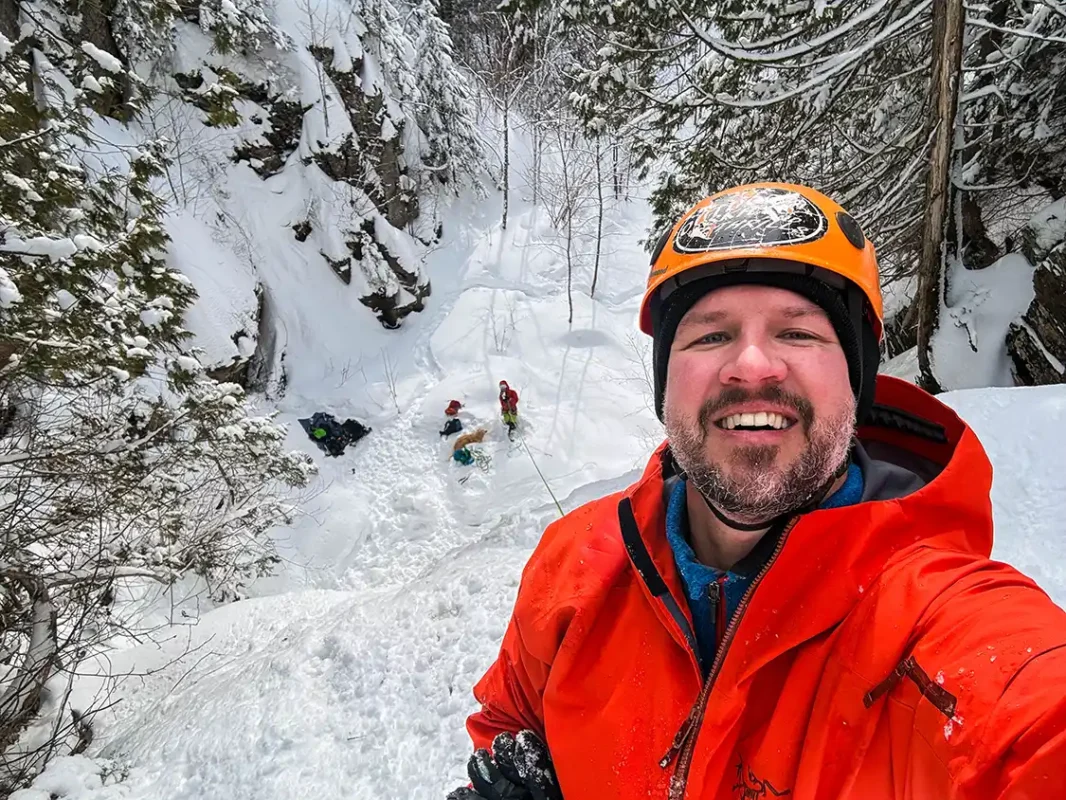 Kevin Wagar posing on top of an ice climbing waterfall in Thunder Bay